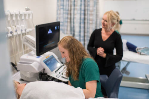 Program instructor observes a student's work
